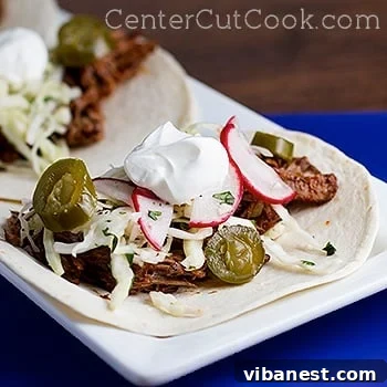 Slow Cooker Shredded Beef Tacos Close-up of slow cooker shredded beef tacos with toppings