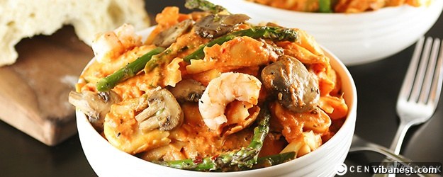 Flavorful tortellini pasta dish with succulent shrimp and sautéed mushrooms, garnished with fresh herbs