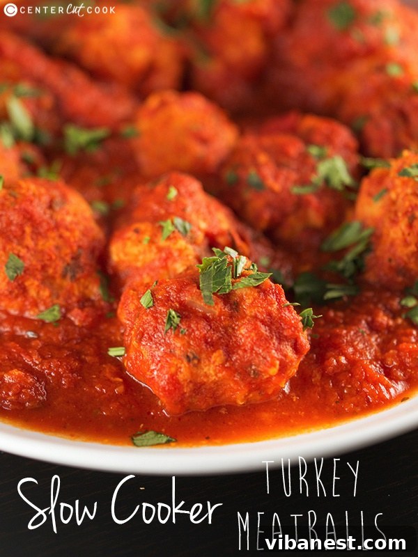 A close-up of slow cooker turkey meatballs in tomato sauce, highlighting their uniform size and tender texture.