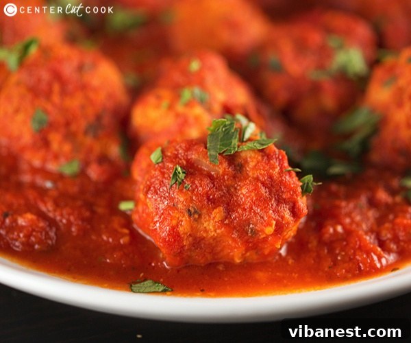 Slow cooker turkey meatballs garnished with fresh parsley, presented beautifully as an appetizer.