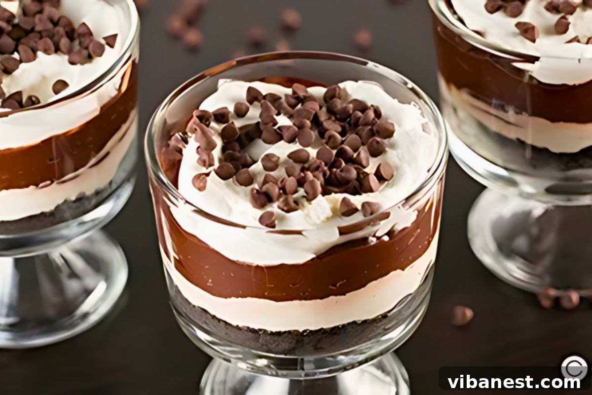 Luscious Chocolate Pudding Parfaits 3 Close-up of easy chocolate pudding parfaits with visible layers of Oreo crust, cheesecake, and chocolate pudding