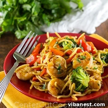 Close-up of spicy shrimp stir-fry in a bowl, garnished with cilantro