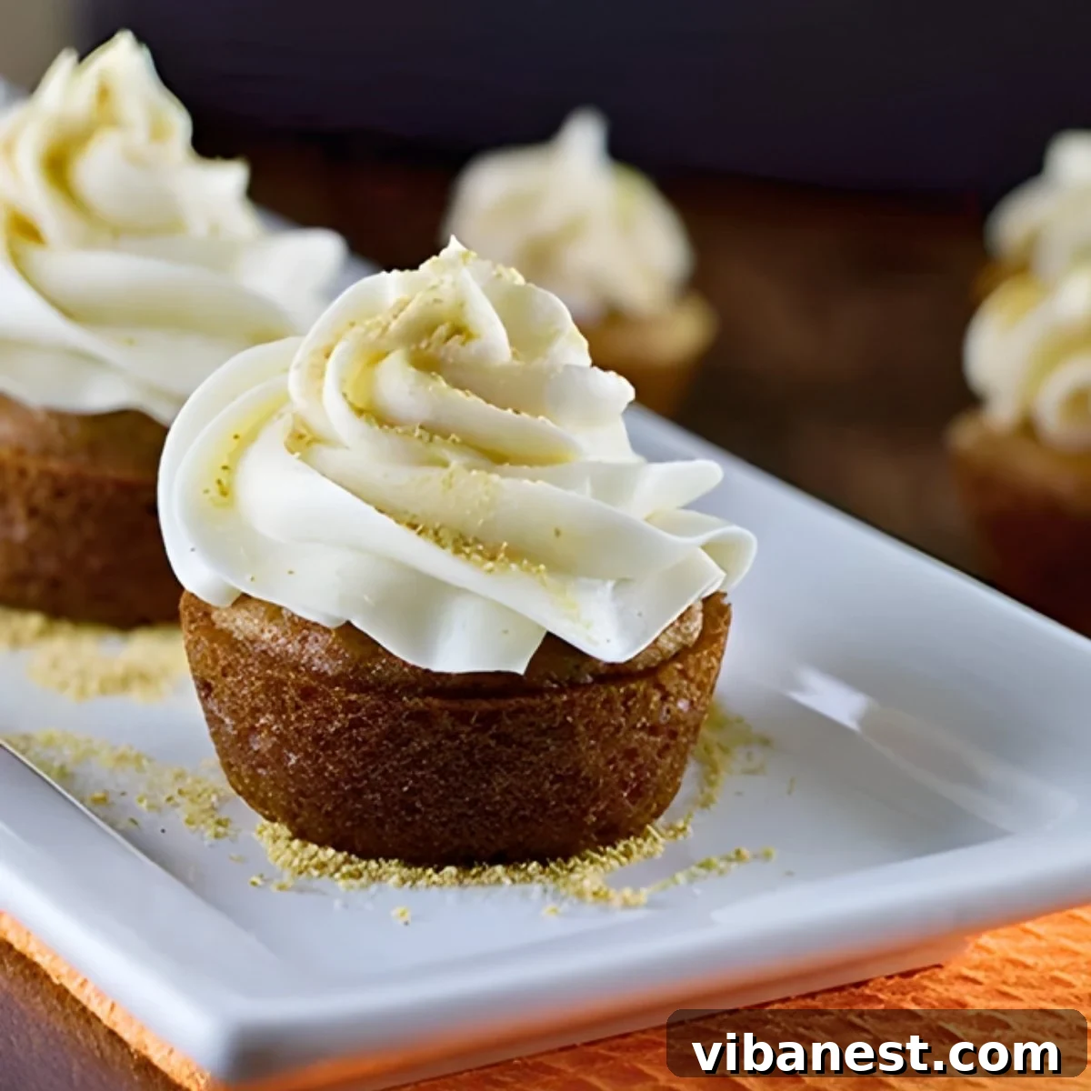 Spiced Pumpkin Pie Cupcakes 2 Irresistible pumpkin pie cupcakes generously topped with creamy cream cheese frosting and a sprinkle of crushed graham crackers, perfect for autumn!