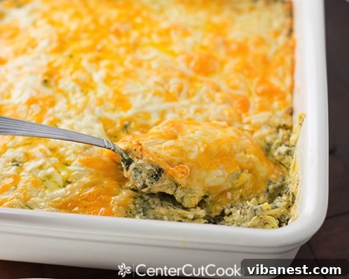 Creamy Spinach Artichoke Dip with Dippers A bowl of creamy spinach artichoke dip with a spoon scooping a portion, surrounded by various dippers like bread and vegetables.