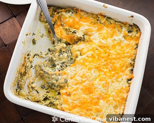Baked Spinach Artichoke Dip Close-up of a golden brown, bubbly spinach artichoke dip baked in a white ceramic dish, ready to be served.