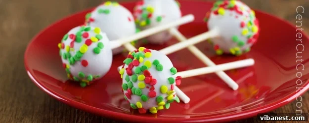 Vibrant and colorful cake pops, beautifully decorated with sprinkles and presented on sticks.