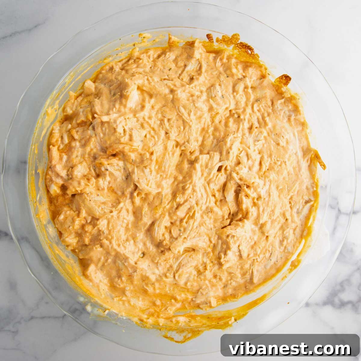 Ultimate Tangy Chicken Dip 8 stirring buffalo chicken dip