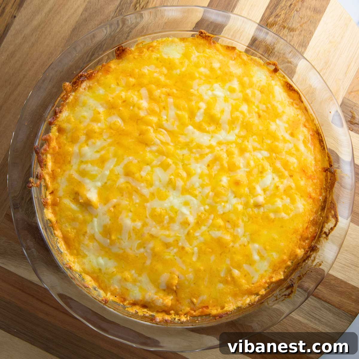 Ultimate Tangy Chicken Dip 10 bubbly buffalo chicken dip garnished with green onion