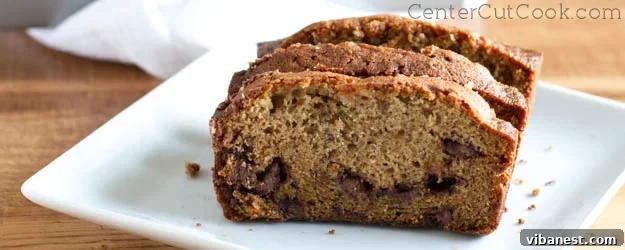 Delicious chocolate chip banana bread loaf, sliced and ready to eat, symbolizing comfort and homemade goodness