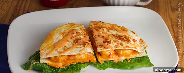 Delicious Bang Bang Shrimp Quesadillas ready to serve with a creamy, spicy sauce
