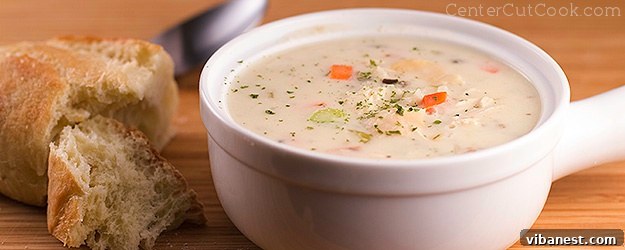Creamy chicken and wild rice soup ready to be served. A close-up of a bowl of creamy chicken and wild rice soup with a spoon, showing the rich texture.