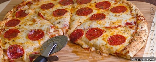 easy pizza dough.jpg Close-up of freshly baked easy pizza dough crust, showing its golden-brown color and inviting texture.