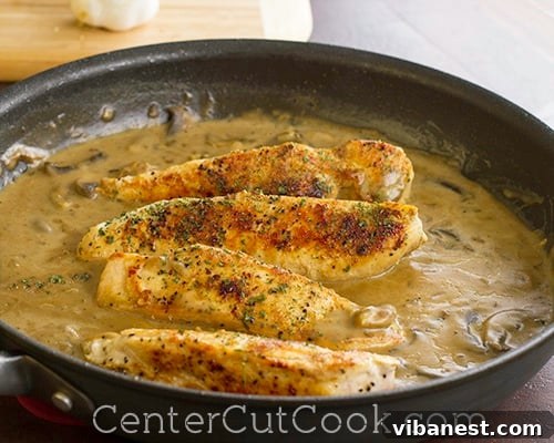 Close-up of perfectly seared chicken breast with creamy mushroom balsamic sauce