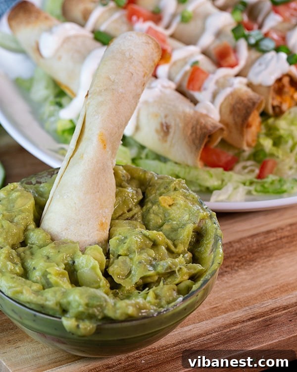 Lean and Luscious Taquito Rolls 7 Oven-baked chicken taquitos served on a plate with fresh guacamole, sour cream, and salsa.