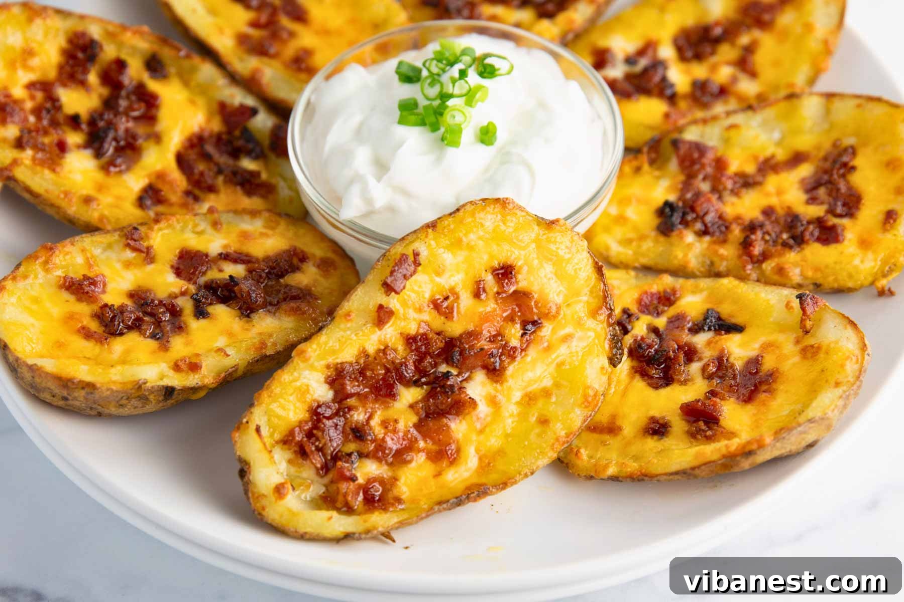 Fully Loaded Potato Boats 14 A wide shot of a platter of loaded potato skins, artfully garnished and ready for a party.