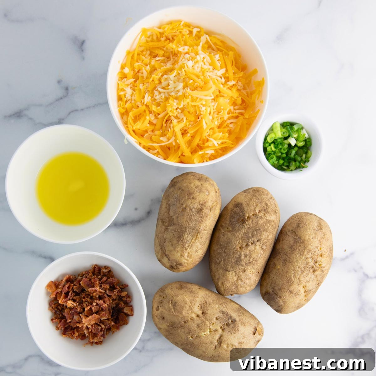 Fully Loaded Potato Boats 5 All the essential ingredients for loaded potato skins neatly arranged: russet potatoes, butter, cheese, bacon, sour cream, and green onions.