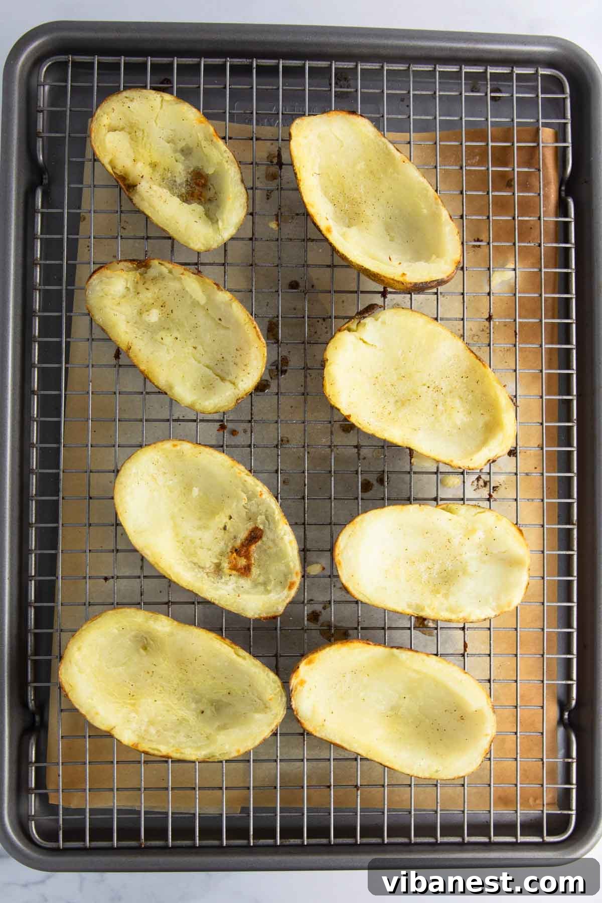 Fully Loaded Potato Boats 9 Crispy, golden-brown potato skins fresh out of the broiler, perfectly prepped for toppings.