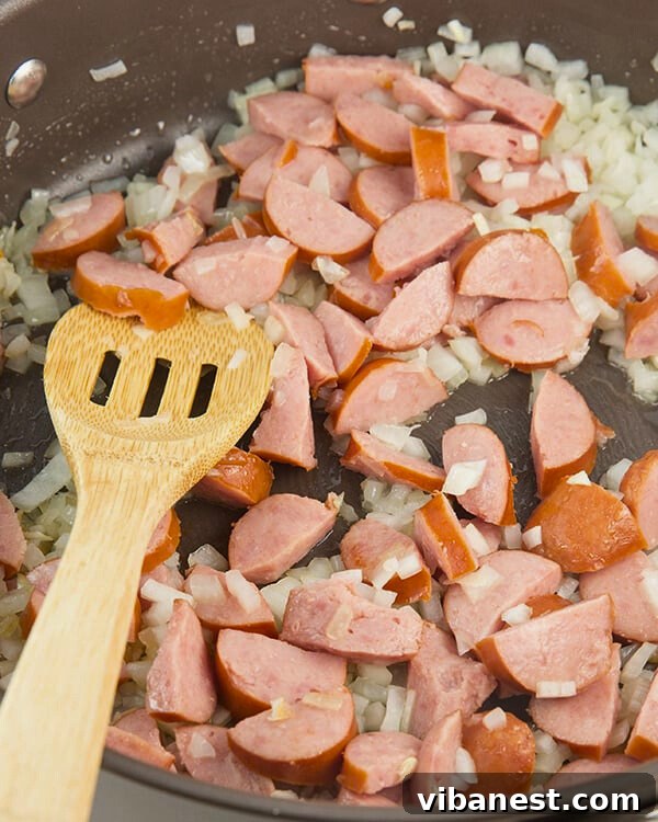 Sizzling Skillet Sausage Delight 5 Sliced sausage and onions sizzling in a hot skillet