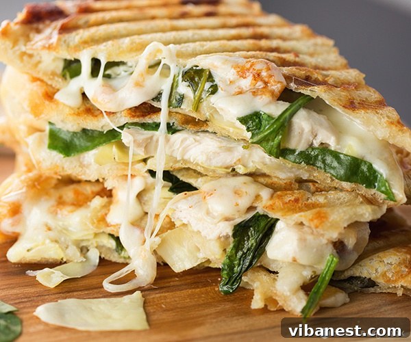 Crispy golden-brown Spinach and Artichoke Panini Grilled Spinach and Artichoke Panini with a delightful golden crust