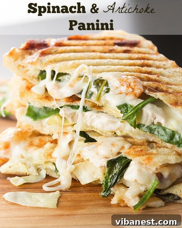 A stack of delicious Spinach Artichoke Paninis Multiple freshly prepared Spinach and Artichoke Paninis, sliced diagonally