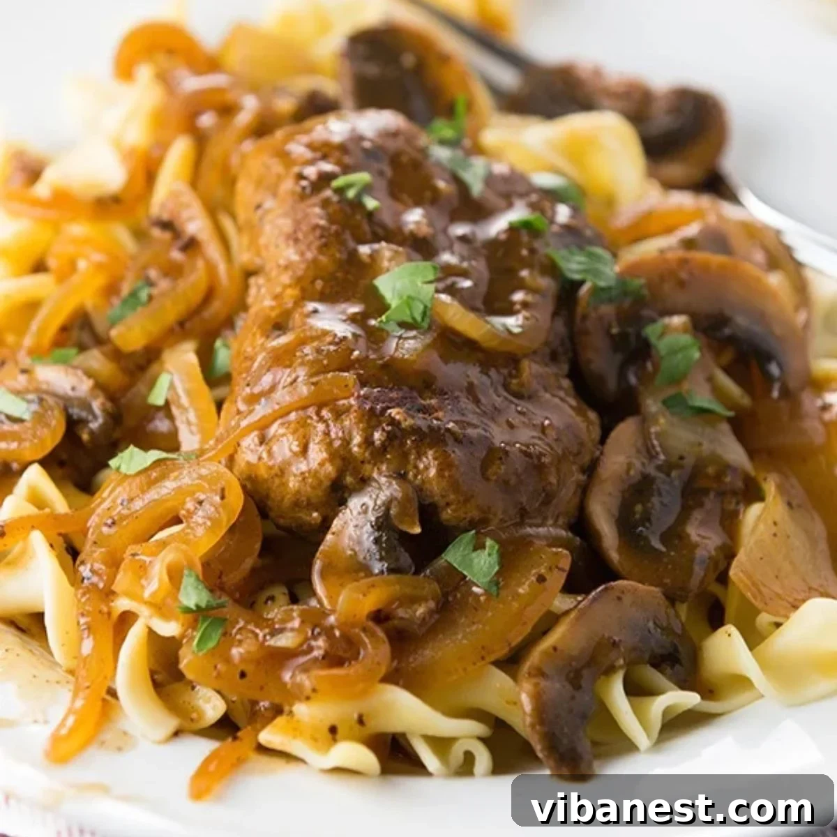 Savory Ground Beef in Mushroom Gravy 2 Salisbury steak with mushrooms and onions served with gravy.