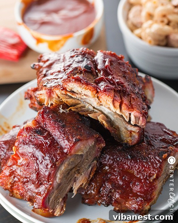 Delicious Fall-Off-The-Bone Grilled BBQ Ribs Perfectly grilled barbecue ribs arranged on a platter, glistening with sauce and ready to serve.