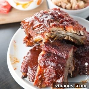 Grilled barbecue ribs served beautifully on a plate, garnished and ready to be enjoyed.