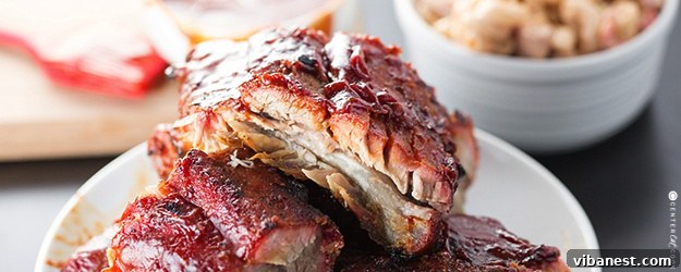 Irresistibly Saucy Grilled BBQ Ribs A close-up of a rack of grilled BBQ ribs, perfectly sauced and tender, ready to be carved and devoured.