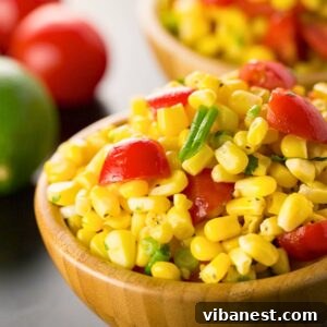 summer corn salad in a white bowl with a spoon