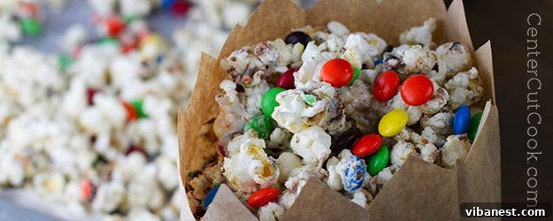 Irresistible white chocolate popcorn with colorful M&M's scattered on top