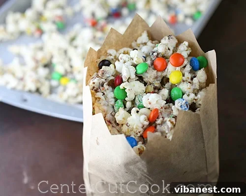 A close-up shot of a bowl filled with white chocolate M&M's popcorn, showcasing its vibrant colors and textures