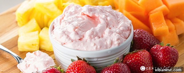 Delicious and creamy fruit dip served with fresh berries and sliced fruit on a white platter, ready for a party