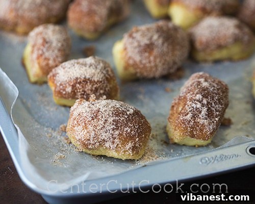 Cinnamon Sugar Coating.jpg Cinnamon sugar pretzel bites being coated in melted butter and a fragrant cinnamon sugar mixture, creating a sweet, glistening crust.