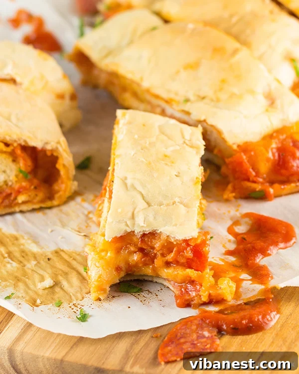 Pepperoni Pizza Bread Roll-Up Close-up of baked Pepperoni Pizza Bread Roll-Up showing golden crust and fillings