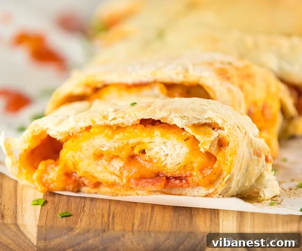 Sliced Pepperoni Pizza Bread Pepperoni Pizza Bread Roll-Up sliced, showcasing layers of cheese, sauce, and pepperoni