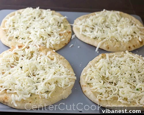 Mozzarella Cheese Layer Sprinkling mozzarella cheese generously over the flatbread