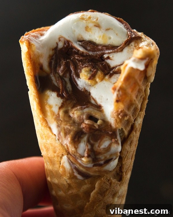 Foil-wrapped campfire cones. Close-up of a prepared Campfire Cone, tightly wrapped in aluminum foil, ready for heating.