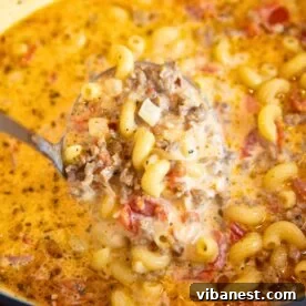 close-up of hearty Italian sausage soup with a creamy broth