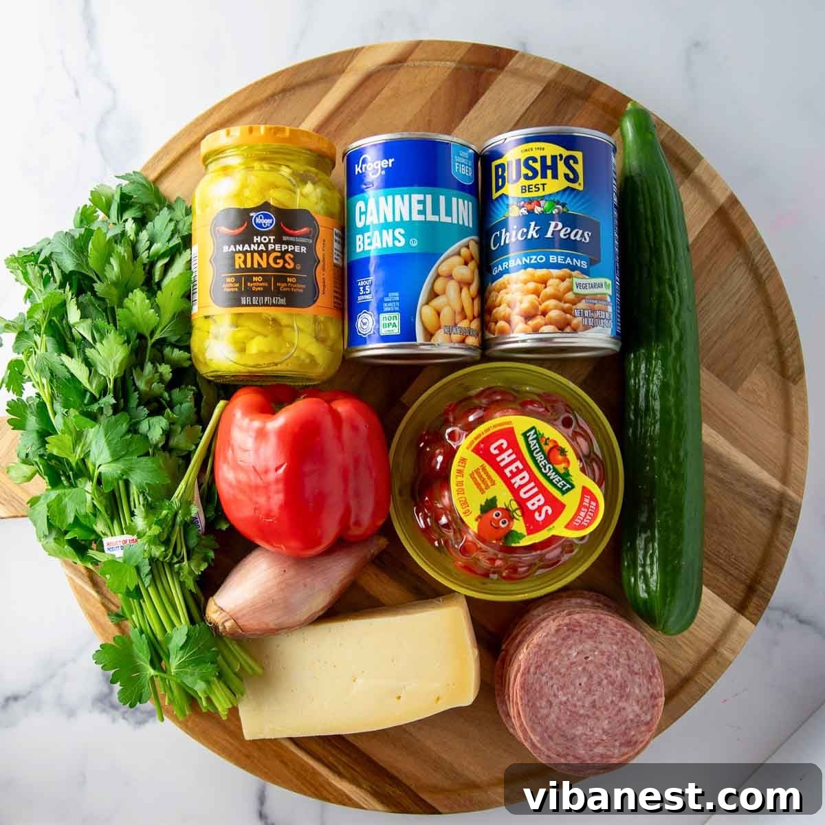 Hearty Italian Bean Salad with Herbs and Vinaigrette 4 Ingredients for Italian Dense bean salad including chickpeas, cannellini beans, salami, cucumber, tomatoes, parmesan, and banana peppers